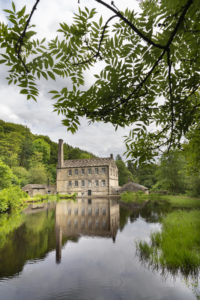 A mill across a pond. 